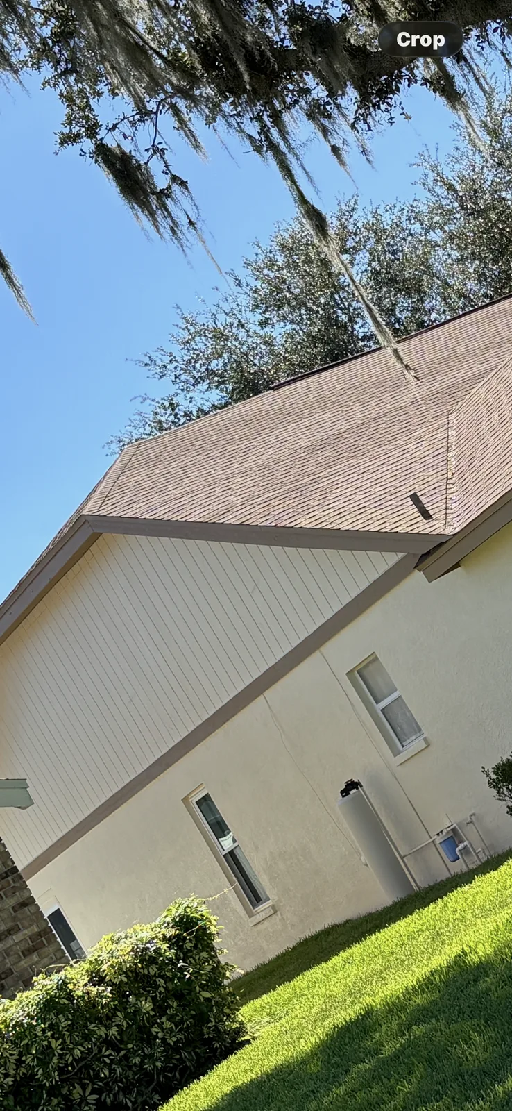 After photo of the same stucco house shown in the two before images