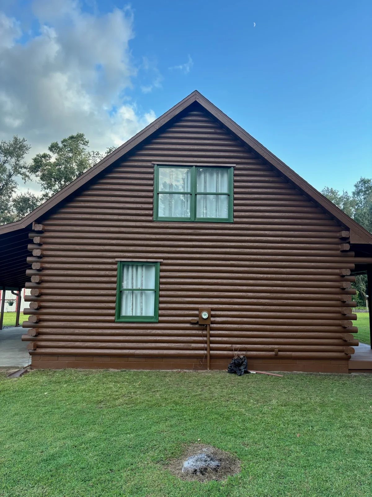 After photo of the same wood-sided house shown in the before side view