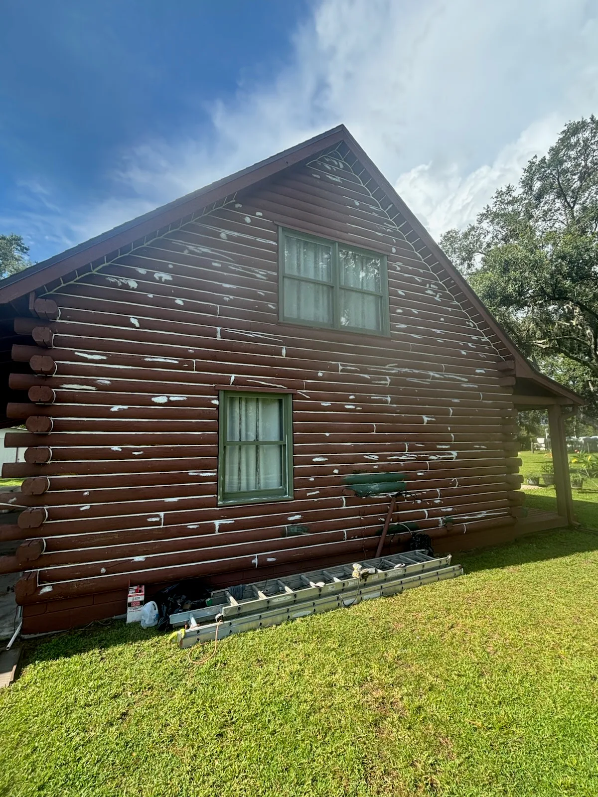Before side view of the same wood-sided house shown in the after photo